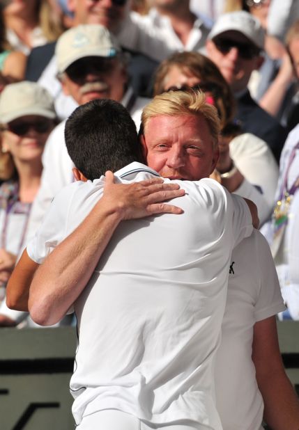 Boris Becker hugs Novak Djokovic after the Serbian wins the first grand slam under his guidance as coach,  beating Roger Federer in a thrilling Wimbledon final in July.