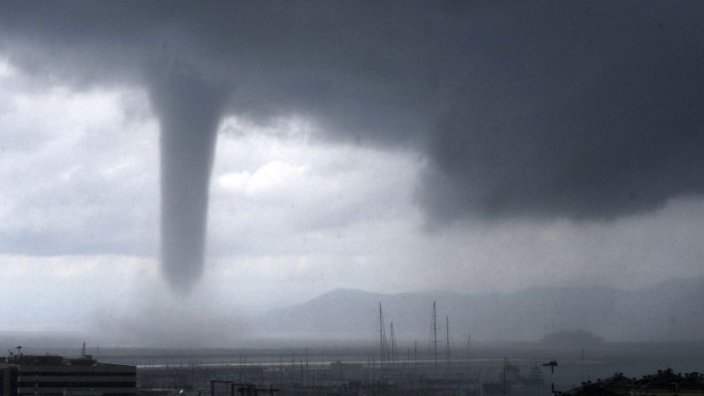 A tornado is seen approaching the coastal city of Genoa, Italy, on Tuesday, August 19. At right, in the background, is the wreckage of the Costa Concordia cruise ship, which was towed recently to Genoa so it could be scrapped.