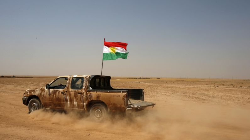Kurdish Peshmerga forces drive a vehicle near the Iraqi town of Makhmur, south of Irbil, after ISIS militants withdrew on Monday, August 18. ISIS has <a href="http://www.cnn.com/2014/06/13/world/gallery/iraq-under-siege/index.html">taken over large swaths of northern and western Iraq</a> as it seeks to create an Islamic caliphate that stretches from Syria to Iraq.
