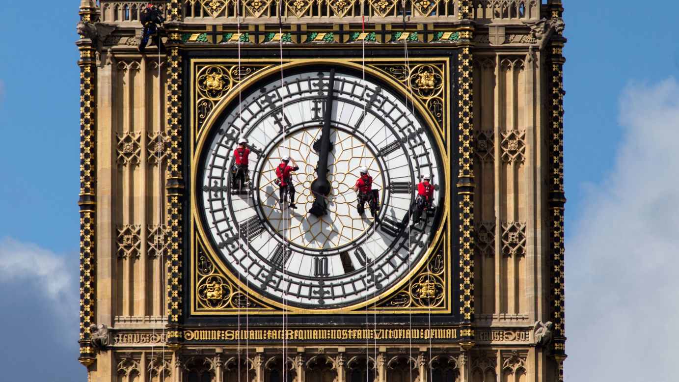 Workers clean the south face of Big Ben, the famous landmark at London's Palace of Westminster, on Tuesday, August 19.