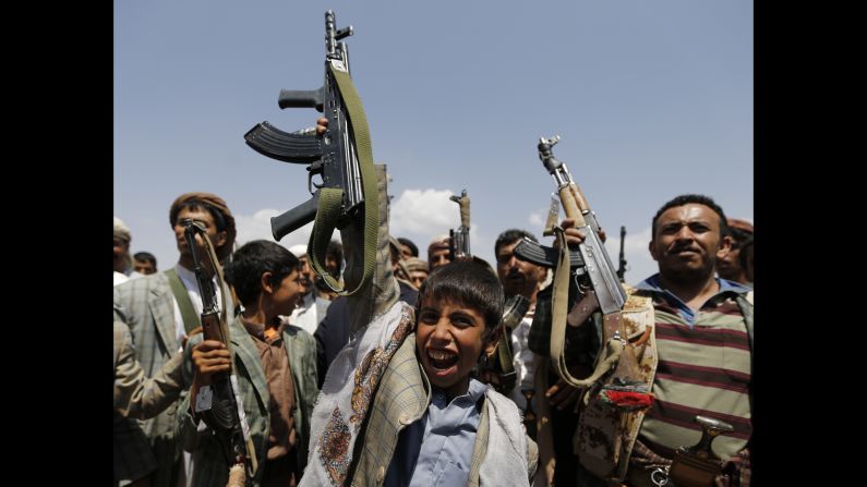 A boy holds up a weapon as he attends an anti-government gathering held by followers of the Shiite Houthi group in Arhab, Yemen, on Sunday, August 17. The Houthis, who control much of the northern Saada province bordering Saudi Arabia, are trying to consolidate their power as the country moves toward a federal system that gives more power to regional authorities.