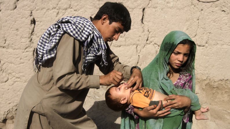 A child is vaccinated for polio on the outskirts of Jalalabad, Afghanistan, on Monday, August 18.