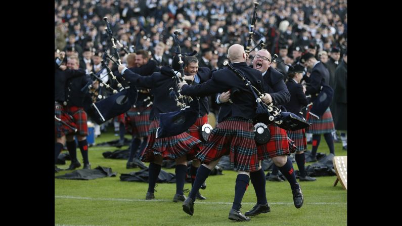 Members of the Field Marshal Montgomery Pipe Band react to winning the annual World Pipe Band Championships in Glasgow, Scotland, on Saturday, August 16.