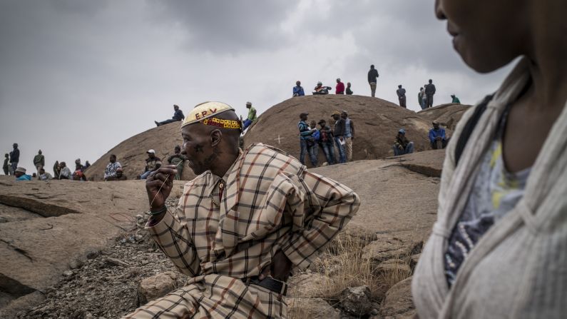 People gather Saturday, August 16, at a mine in Marikana, South Africa, where 34 striking workers were <a href="http://www.cnn.com/2013/08/15/world/africa/mabuse-marikana-noki/index.html">fatally shot by police</a> two years ago. Police said they acted in self-defense against a mob of miners armed with clubs and machetes.