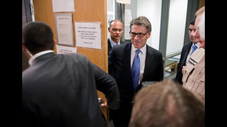 Texas Gov. Rick Perry leaves the booking area at the Travis County Courthouse in Austin, Texas, on Tuesday, August 19. He was <a href="http://www.cnn.com/2014/08/19/politics/perry-indictment-booked/index.html">charged with two felony counts</a> related to his handling of a local political controversy. Perry and his team of lawyers are framing the indictment as a political attack. "I'm going to enter this courthouse with my head held high knowing that the actions I took were not only lawful and legal but right," Perry told reporters.