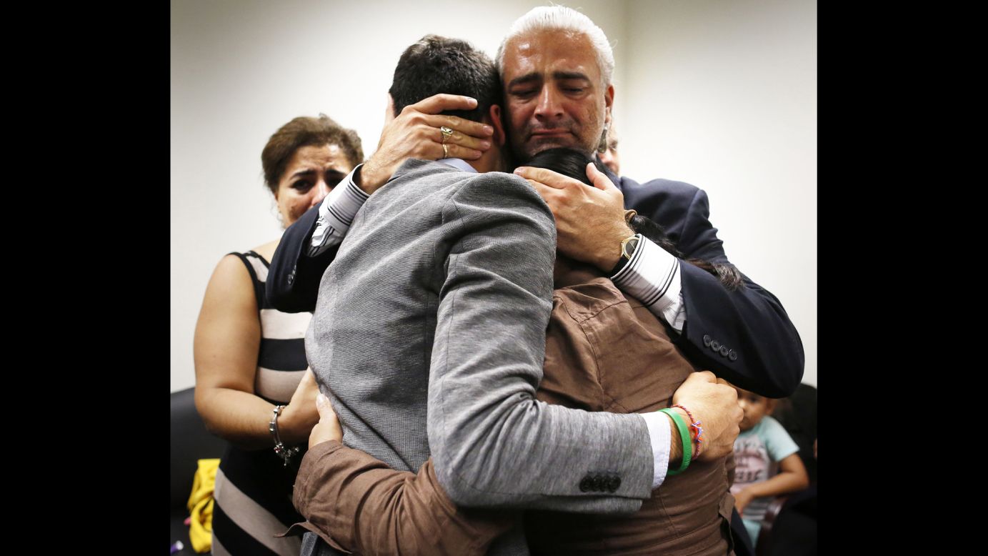 Diego Aguilar, the uncle of slain college student Christian Aguilar, hugs Christian's younger brother, Alex, in a Gainesville, Florida, courtroom Friday, August 15, after Pedro Bravo was found guilty of murdering Aguilar in 2012.
