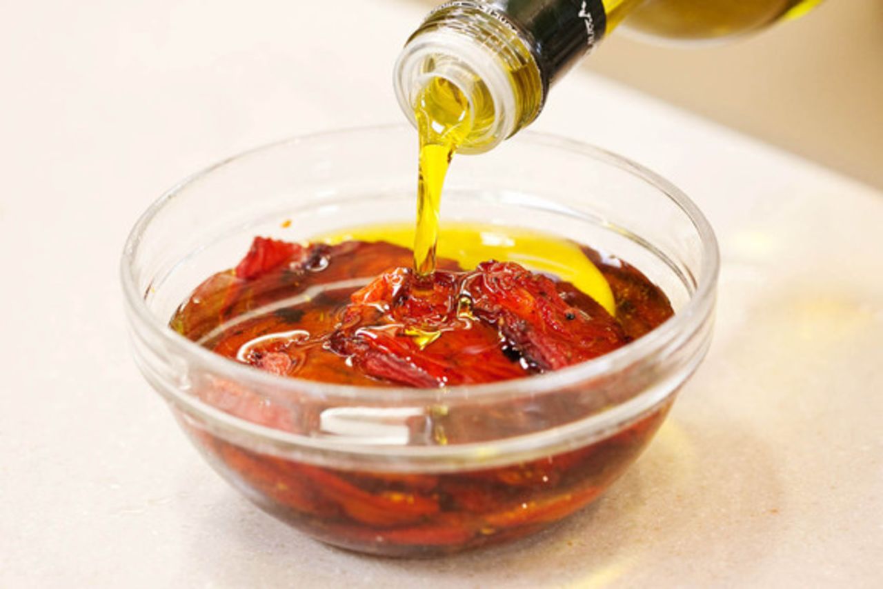 Finally, let the tomatoes cool to room temperature on the sheets, and then transfer them to a bowl (or other storage container). Cover them completely with extra-virgin olive oil, then wrap the whole thing in plastic and refrigerate them for up to 2 months. Alternatively, you can leave out the oil and instead freeze the dried tomatoes in an airtight container—zipper-lock bags work great—for up to 3 months.