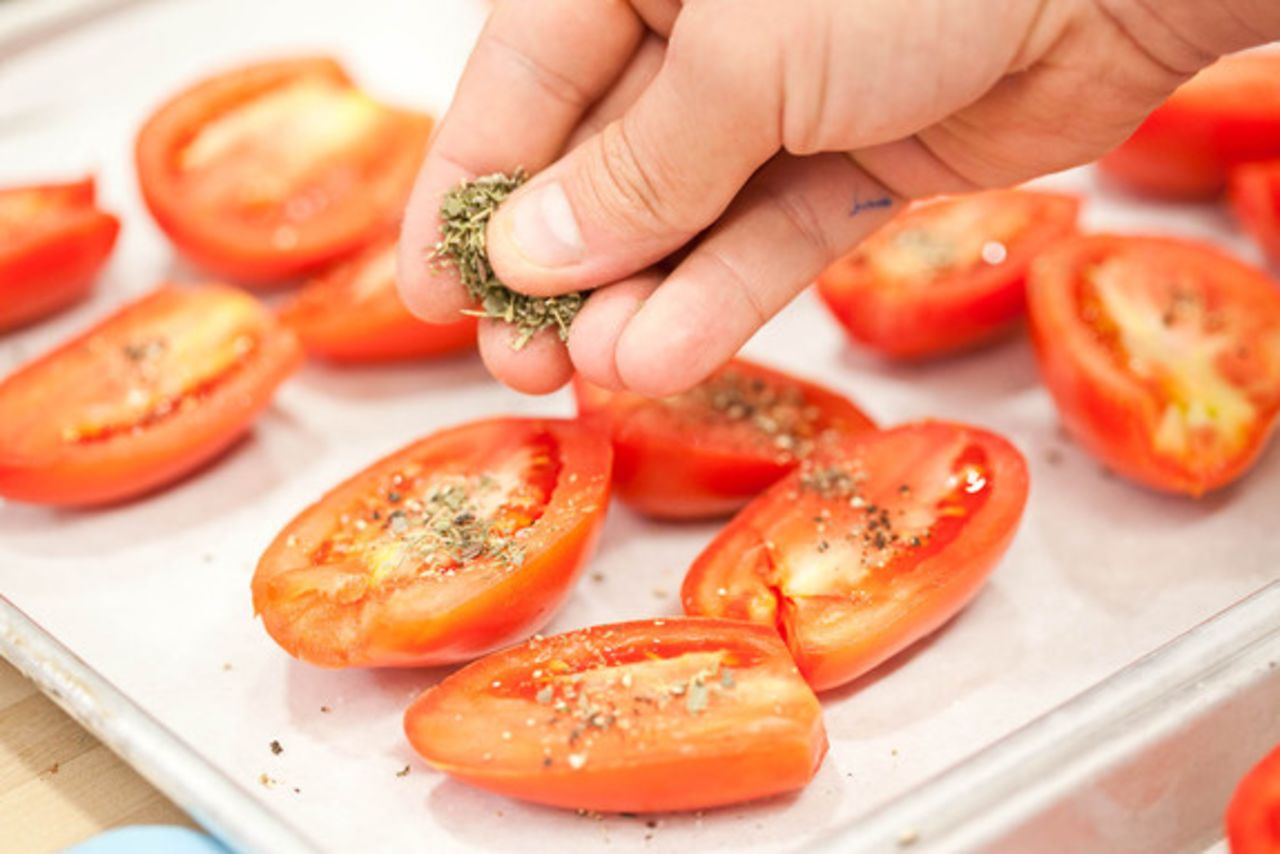 Season the tomatoes with Kosher salt, a lot of freshly cracked black pepper, and dried herbs de Provence. Thyme and oregano make good substitutions for the herbs de Provence (mint and rosemary do not); you can use fresh herbs, but dried work just fine.