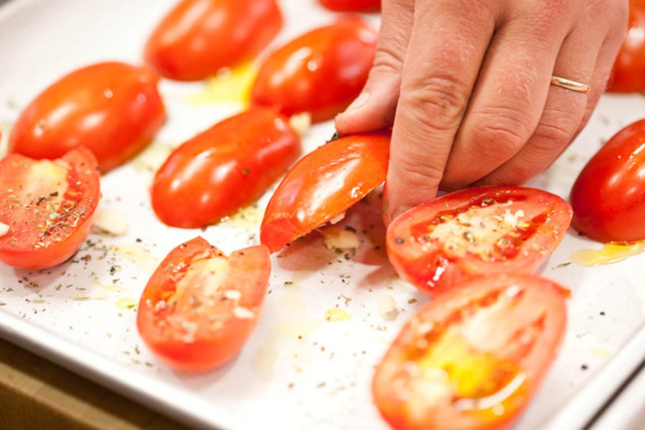 Flip the seasoned tomatoes over, cut-side down.