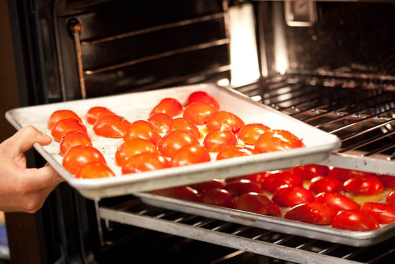 Place the tomatoes in a preheated 425-degree oven for 30 minutes (or until the skins wrinkle up a bit and start to get brown in places).
