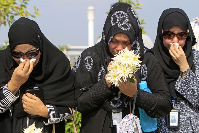 People cried as they waited outside Bunga Raya Complex at Kuala Lumpur International Airport before victims' bodies were flown back from Amsterdam.
