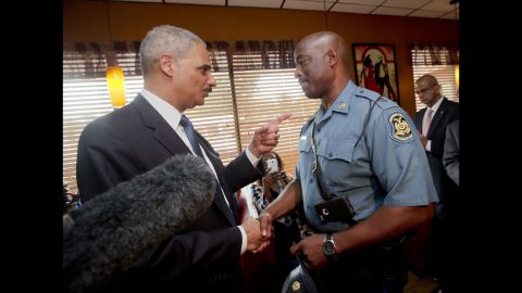 U.S. Attorney General Eric Holder meets with Capt. Ron Johnson of the Missouri State Highway Patrol at a Ferguson restaurant on August 20, 2014. Holder came to Missouri to talk to community leaders and review the federal civil rights investigation into Brown's shooting.