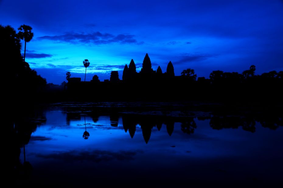 Hundreds of tourists flock to the ancient city of <a href="http://ireport.cnn.com/docs/DOC-1027386">Angkor Wat</a> in Cambodia each morning to watch the sun rise over its iconic temple.