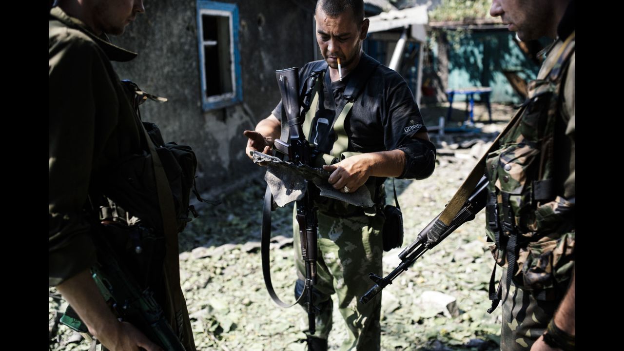 A pro-Russian rebel holds shrapnel from a rocket after shelling in Donetsk on August 22.