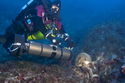 Foley said: "It's actually a treasure ship and there are just no two ways about it. There are 36, 38 statues of marble and bronze, gold jewelry, very high quality glass artifacts that came from the East Mediterranean. Just the highest quality stuff that was available in the first and second centuries BC." Pictured, technical diver Phillip Short inspects an amphora on a previous reconnaissance dive. 