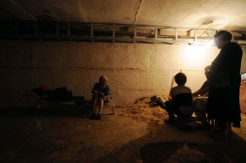 Locals of the community take refuge inside a cellar.