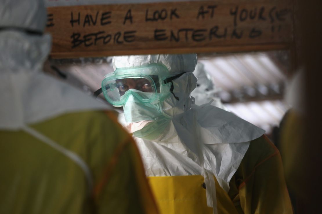 A member of Doctors Without Borders prepares to enter a high-risk area of an Ebola treatment center in Liberia.