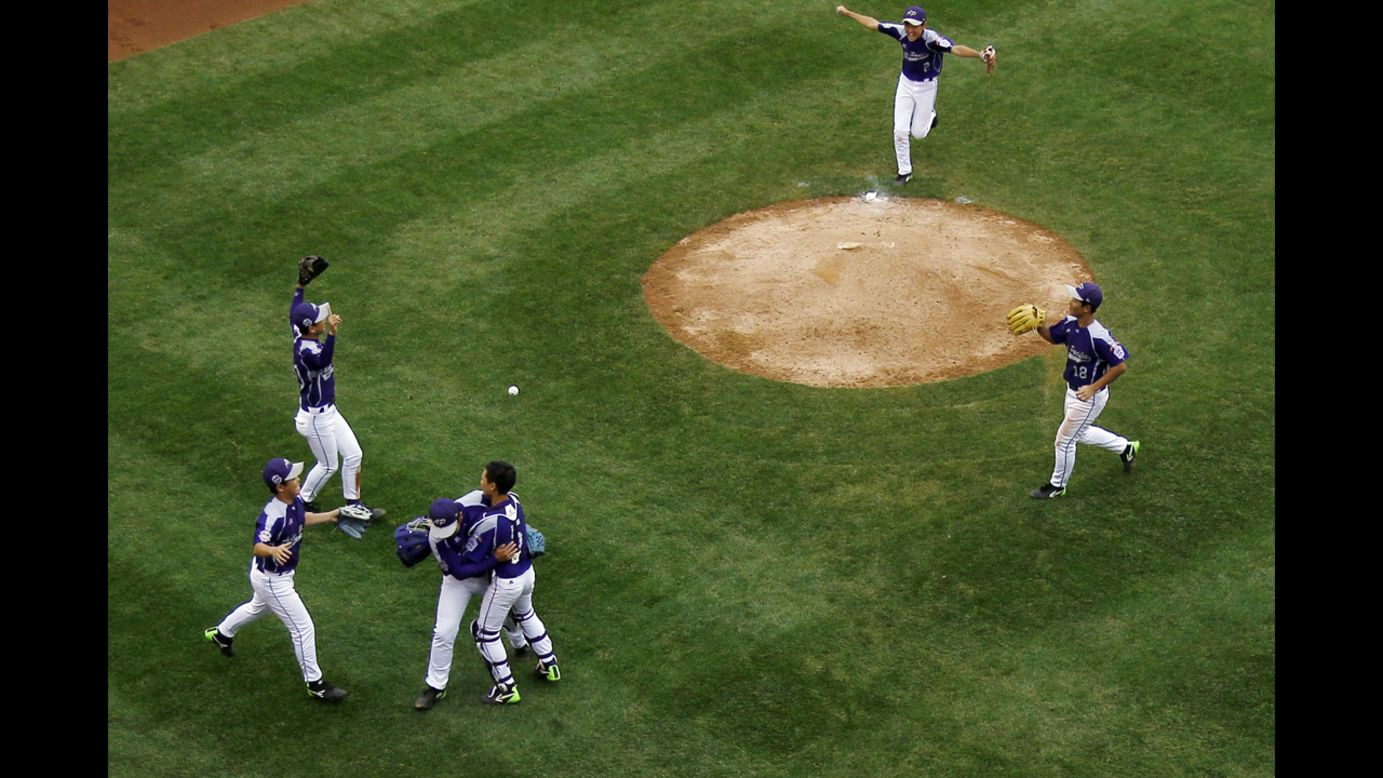 South Korea players celebrate after defeating Japan 12-3 on August 23.
