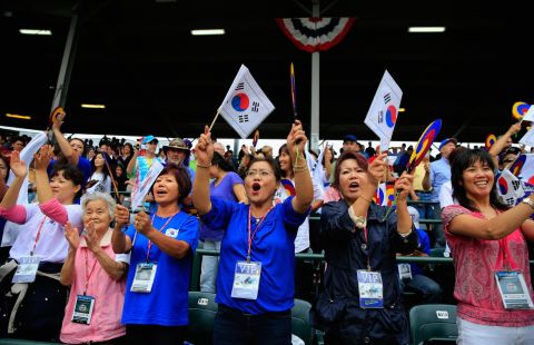 Fans of the South Korean squad cheer between innings on August 23.