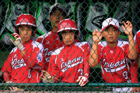 Members of Team Japan look on from the dugout during the fifth inning of their 12-3 loss to Team Asia-Pacific on August 23.
