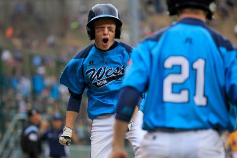 Justin Hausner of the West team from Las Vegas celebrates after scoring a first inning run against the Great Lakes Team from Chicago on August 23.
