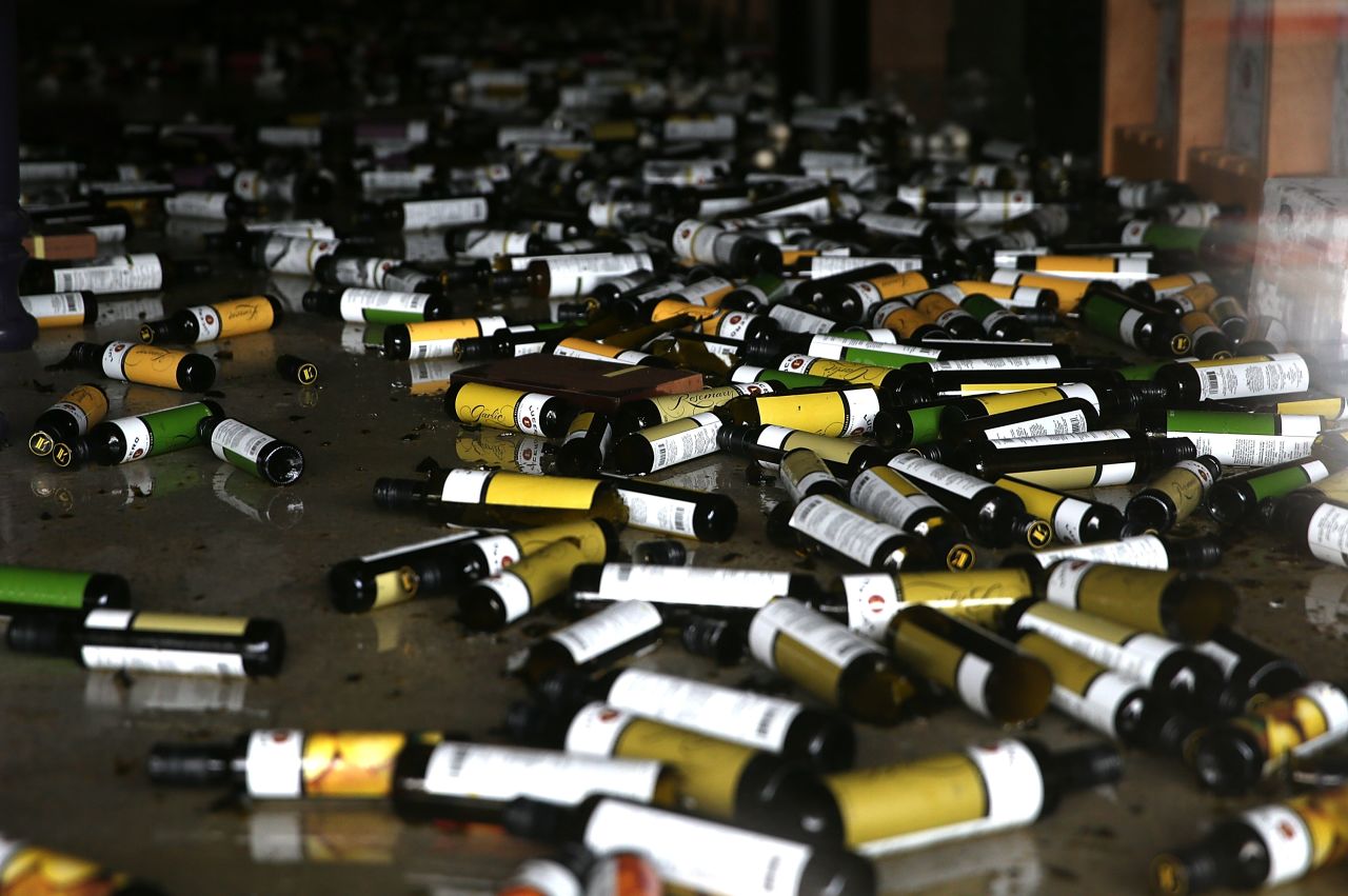  Bottles of olive oil and vinegar lie on the floor of a damaged business on August 24 in Napa.