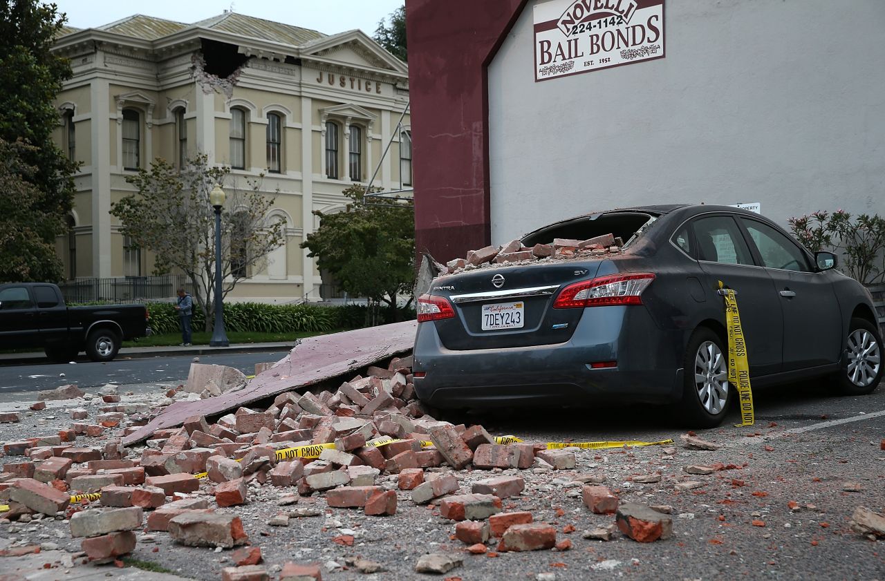 Bricks from a damaged building sit atop a car on August 24 in Napa. 