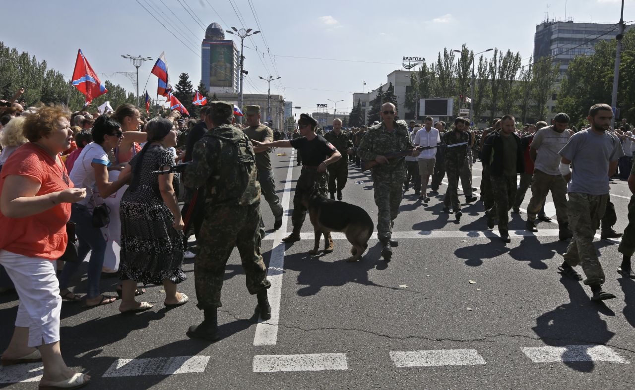 People yell as Ukrainian prisoners are paraded through Donetsk in eastern Ukraine on August 24. 