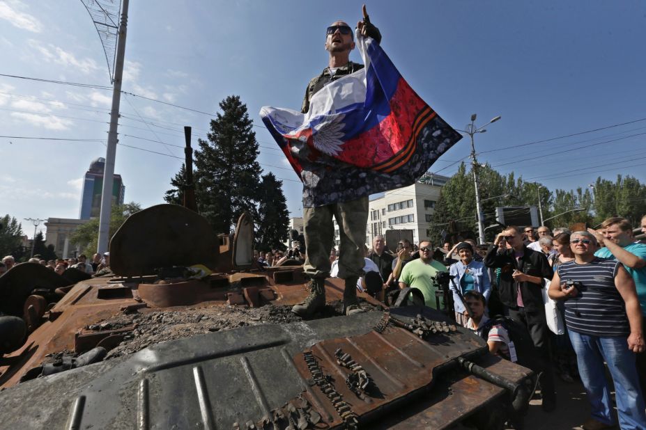 A pro-Russian rebel delivers a speech atop a damaged Ukrainian armored personnel carrier in Donetsk on August 24.