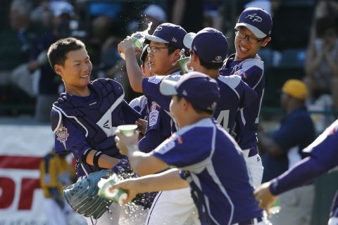 South Korea's Hae Chan-choi, center, celebrates with teammates after getting the final out of a 8-4 win against Chicago. 