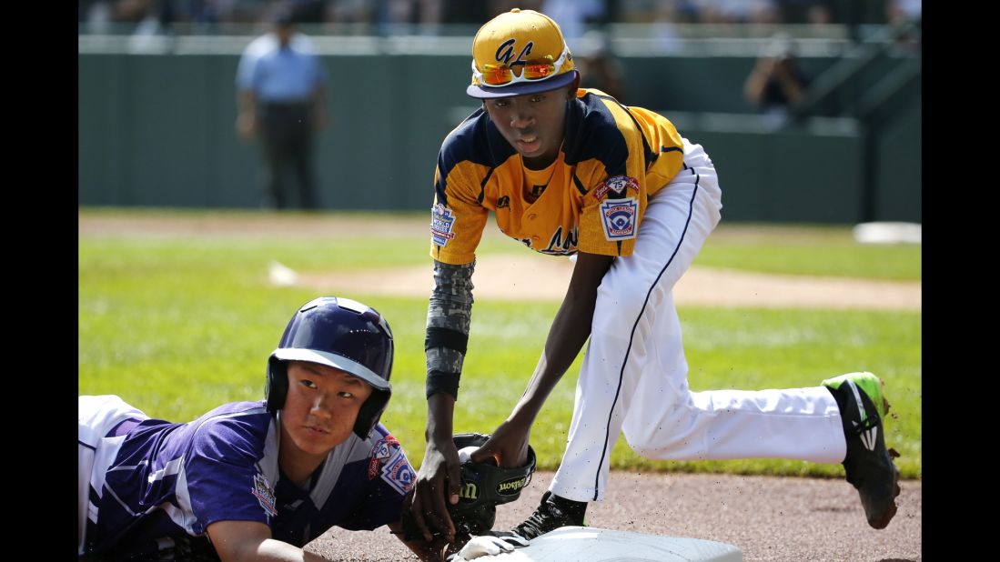 South Korea's Jae Yeong-hwang, left, is tagged out by Chicago's Cameron Bufford while attempting to steal third.