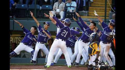 South Korea's Hae Chan-choi, No.  21, celebrates with teammates after hitting a two-run home run off Chicago's Brandon Green in the sixth inning on August 24. 