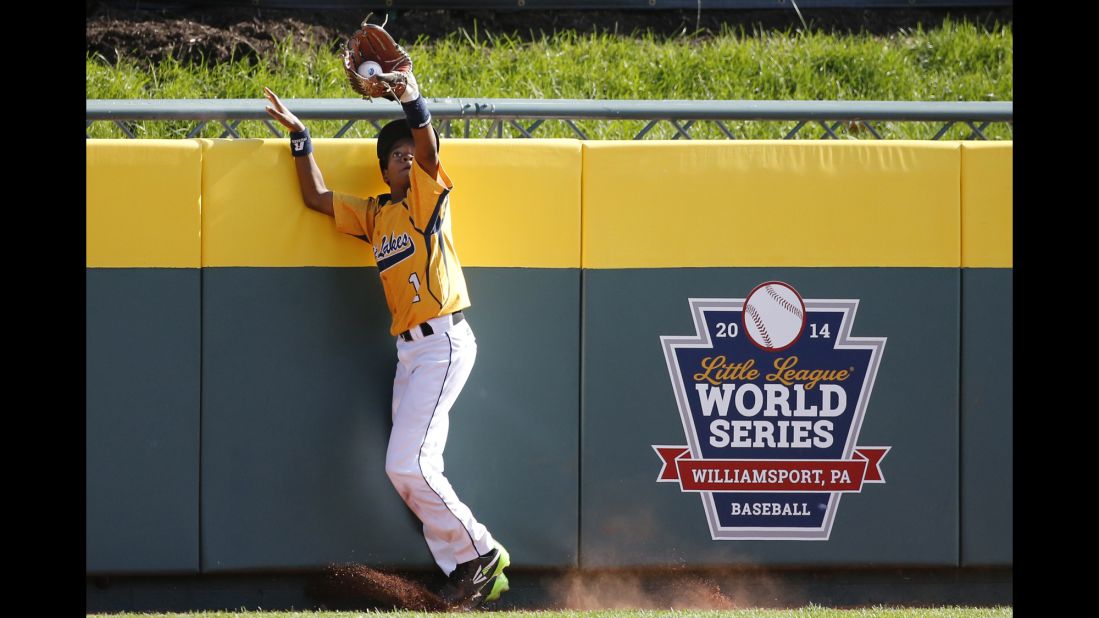 Chicago center fielder DJ Butler catches a ball by South Korea's Jae Yeong-hwang at the wall on August 24. 
