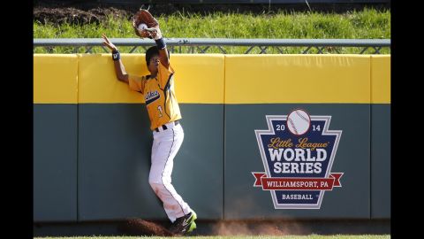 Chicago center fielder DJ Butler catches a ball by South Korea's Jae Yeong-hwang at the wall on August 24. 