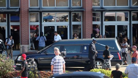 A hearse sits outside the church before the funeral.