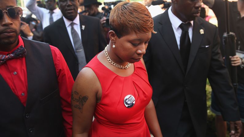 Brown's mother, Lesley McSpadden, arrives at Friendly Temple Missionary Baptist Church for the funeral service.