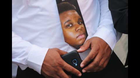 A Brown family member wears a tie with Michael Brown's face on it.
