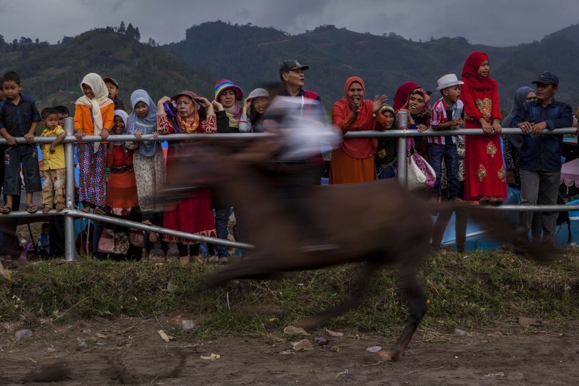 AUGUST 25 - CENTRAL ACEH, INDONESIA: Acehnese spectators watch the Takengon traditional horse races. Young jockeys ride bareback during the races that mark Indonesian independence.