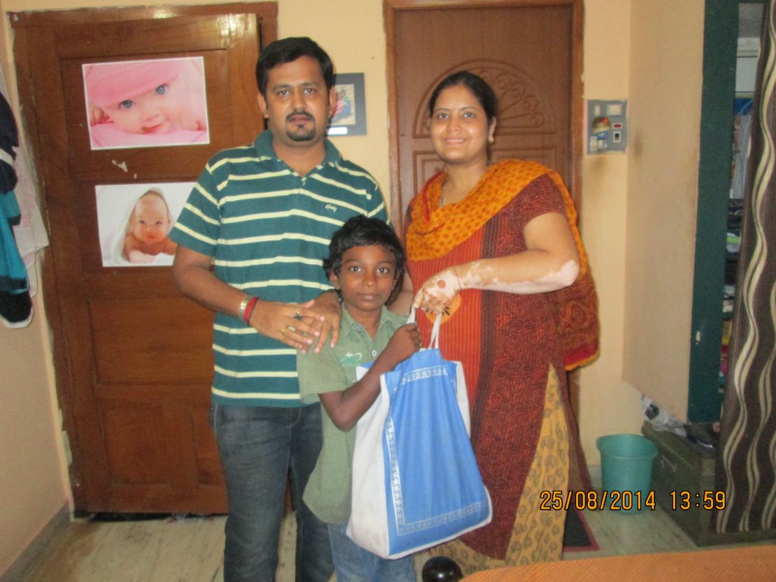 Abhilekha Rampuria (right) gives a boy, Balaji, 5kgs of rice. She says: "He has 2 siblings. His mother works as housemaid. They buy daily 1/2kg of rice to serve their hunger needs. He does not have a father. Still they don't beg."