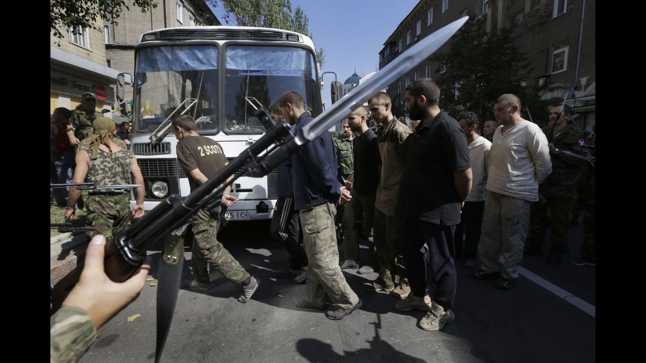 Pro-Russian rebels escort captured Ukrainian soldiers in a central square in Donetsk on Sunday, August 24.