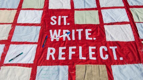 People contribute to the quilt in different ways. Some people make squares ahead of time in workshops led by community organizations. When it's on public display, visitors are invited to share stories in designated places on the quilt.