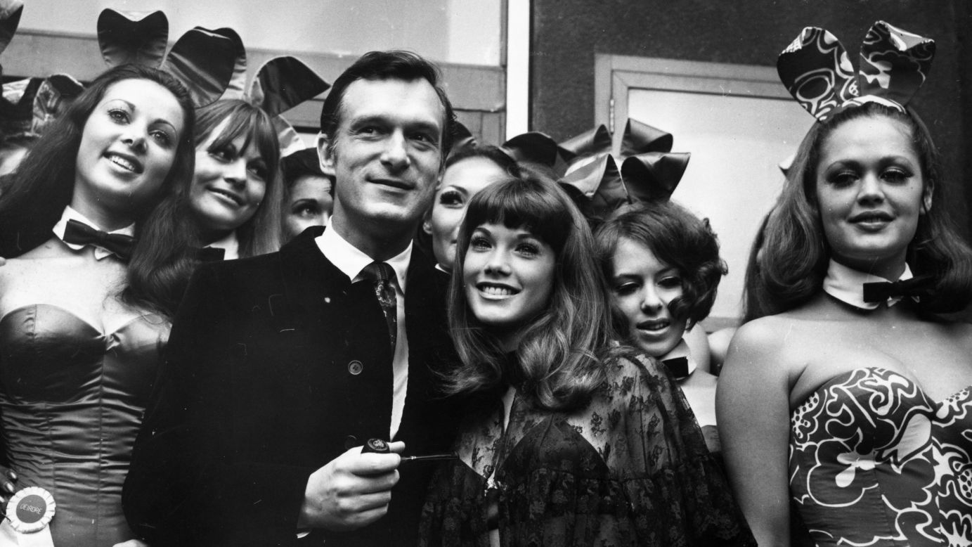 Playboy chief Hugh Hefner poses with English 'Bunny Girls' at his London Playboy Club. The iconic uniform of Playboy Club waitresses includes a white collar and black bow tie -- and not a lot else.