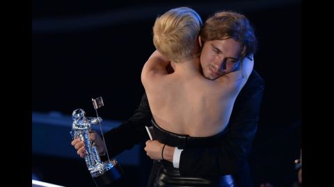 Cyrus and Helt embrace following his acceptance speech given on behalf of the singer who won Video of the Year for "Wrecking Ball" during the 2014 MTV Video Music Awards. 