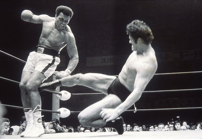 Former Japanese wrestler turned politician Kanji "Antonio" Inoki strikes out at Muhammad Ali during an exhibition fight in Tokyo, July 5, 1976.