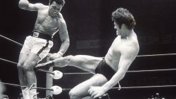 5 Jul 1976: Muhammad Ali fends off a kick from wrestler Antonio Inoki during an exhibition fight in Tokyo, Japan. \ Mandatory Credit: Allsport Hulton/Archive