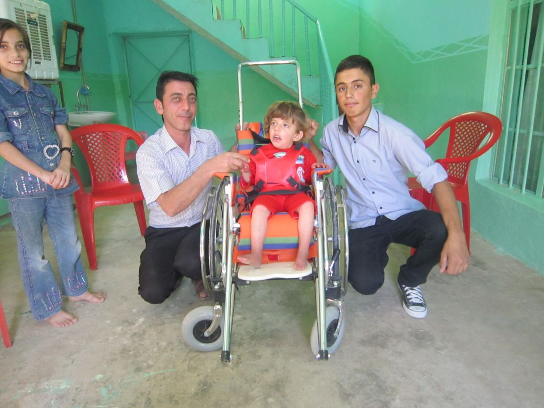 Azwan, right, used to help deliver wheelchairs for disabled Iraqi kids.