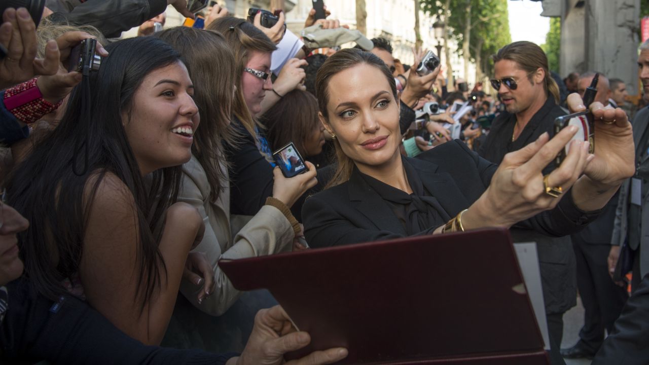 Jolie takes a selfie with fans at the premiere of Pitt's "World War Z" in Paris in June 2013.