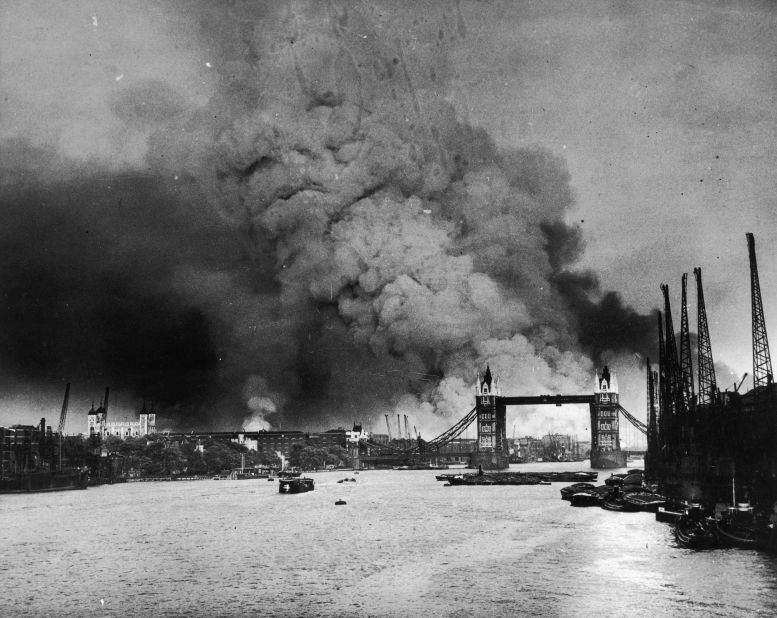 Smoke rises behind Tower Bridge during the first mass daylight bombing of London on September 7, 1940. 