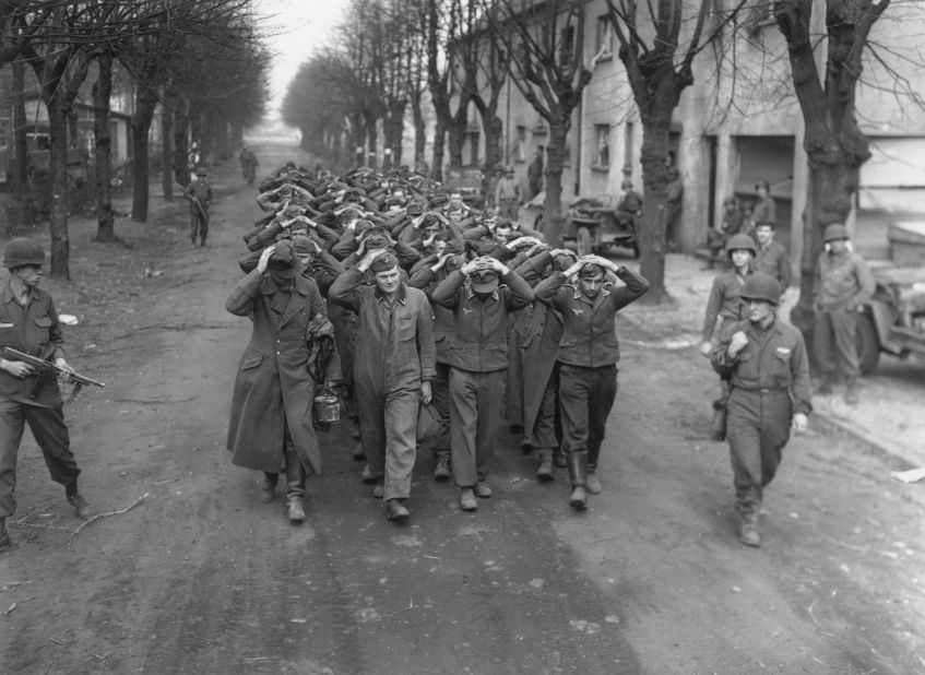 German prisoners captured at Friedrichsfeld march through a town in Germany after the crossing of the Rhine River by the U.S. 9th Army on March 26, 1945.