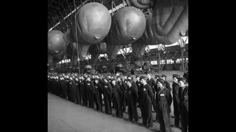 Balloon operators from Britain's Women's Auxiliary Air Force, or WAAF, report for inspection in a hangar used to store balloons, at a facility in the UK. During World War II, women played a significant role in the war effort. They took jobs in "defense plants and volunteered for war-related organizations, in addition to managing their households," according to the World War II museum in New Orleans.